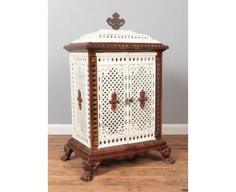 An enamel cast iron stove with lion paw feet and urn shaped finial. Height 102cm, Width 59cm, Depth 39cm.  