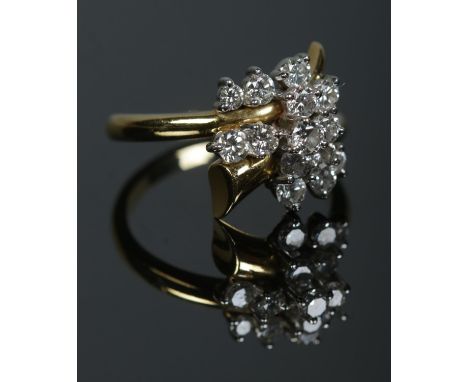 An 18ct gold and diamond trumpet cluster ring. Size R 1/2. 7.03g.  