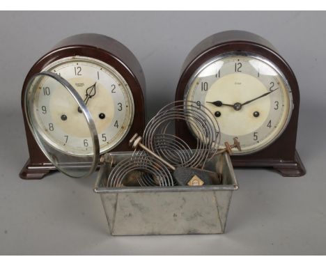 Two Smiths Enfield bakelite cased mantle clocks along with a small collection of clock spares and repairs.  Pendulums present