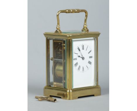 An early 20th century brass and glass repeater carriage clock. Having swing handle, Roman numeral markers and chiming on a co