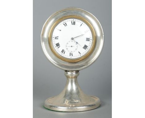 A George V silver desk clock of circular form on pedestal base. Assayed Birmingham 1922 with partial makers mark. Height 14cm