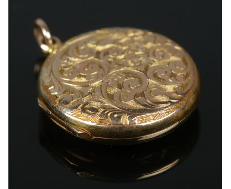 An early 20th century locket with chased decoration. Stamped 15ct to back. 4.27g.  Some light surface scratches. Hinge and cl
