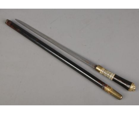 An ebonised short sword stick with carved bone collar and brass lion head pommel. Length of blade 36cm. Total length 59cm. CA