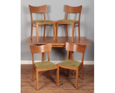 A light oak drawer leaf dining table with four matching chairs.  Split to back rest of one chair.