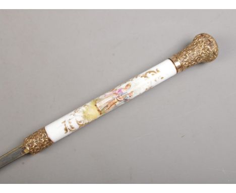 A bamboo cased sword stick. Having porcelain grip, hand painted with Sevres style scenes and gilt metal pommel and collar. Le