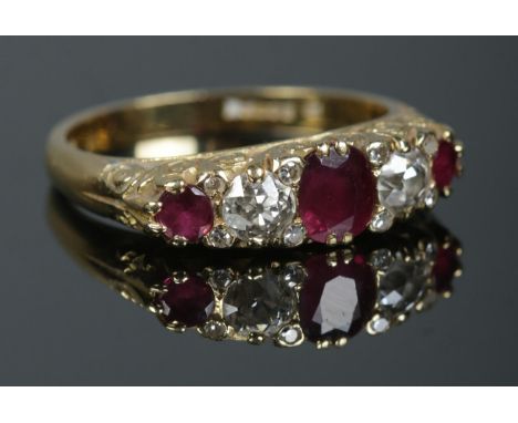 An 18ct gold, diamond and ruby five stone diamond ring. Approximately 0.5ct diamond in total. Size R. 6.63g.  Some surface sc