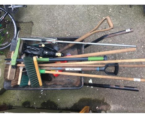 A wheelbarrow and garden tools