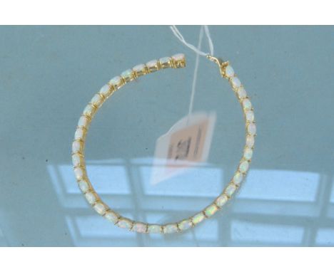 A 14ct gold opal set line bracelet, weight approx 9.5g