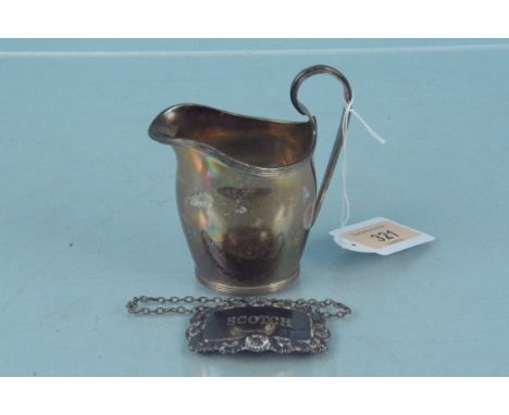 A small silver cream jug and a silver Scotch label, cream jug hallmarked Chester 1912, total weight approx 110g 