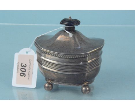 A silver tea caddy with wooden finial on four bun feet, hallmarked Sheffield 1902, weight approx 140g