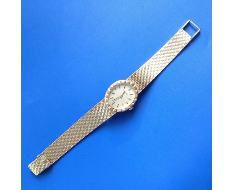 A lady's 18ct gold Jaeger LeCoultre bracelet wrist watch, having oval champagne dial, baton numerals, ozier decorated bezel a