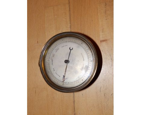 A circular brass wall aneroid barometer – 'DC', 5” diameter.