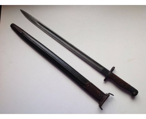 A WWI British 1907 pattern bayonet in scabbard, the blade by Wilkinson and with numerous inspection marks.