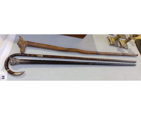 A silver mounted walking stick and two others. (3)