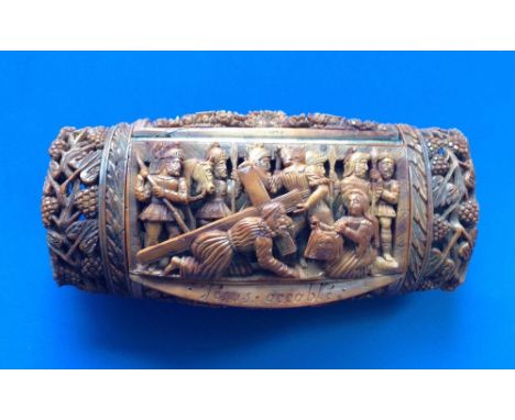 A 19thC French coquilla nut snuff box, the hinged cover undercut in high relief to show Christ on the road to Calvary, with t