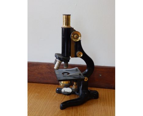 A black lacquered Watson & Co. 'Kima' microscope.