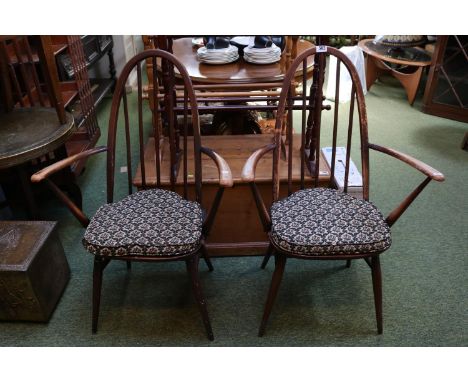 Pair of Ercol Dark Elm Elbow chairs with upholstered seats 