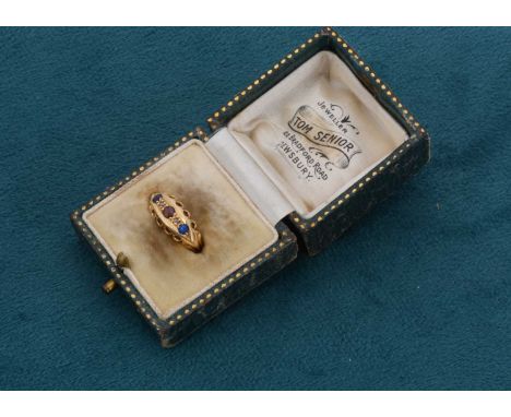 An Edwardian 18ct gold five stone dress ring, set with two blue sapphire, two diamond chips centred with GTD (garnet topped d