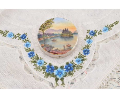 A circular silver, enamelled and painted compact depicting row boat on lake, A circular silver, enamelled and painted compact