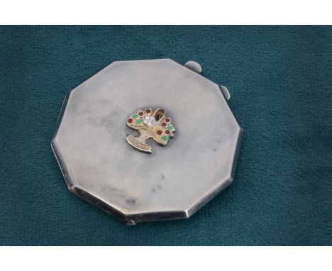 An Art Deco silver compact octagonal, some dents, small enamelled basket to lid, glued, 6.5cm wide
