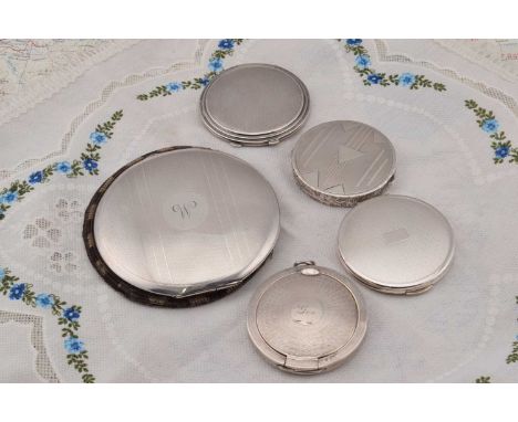 Five circular silver engine turned compacts, Five circular silver engine turned compacts, largest flapjack style, monogrammed