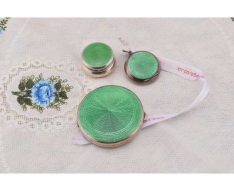 Three silver circular green guilloche enamelled compacts, Three silver circular green guilloche enamelled compacts, comprisin