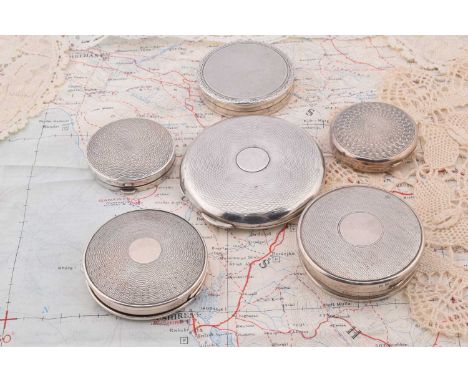 Six circular silver engine turned compacts, Six circular silver engine turned compacts, largest Chester 1915, 7cm diameter, B