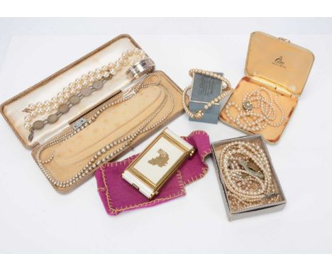 A silver napkin ring, a string of simulated pearls, Berlin Brit Zone compact and manicure set and other items including cap b