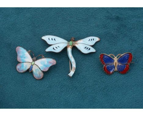 A Sterling marked enamel dragonfly brooch, in light blue and green enamel, together with a plated brooch and another in base 