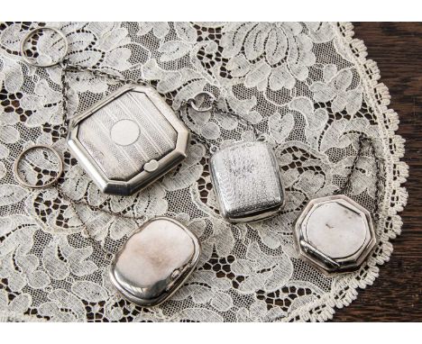Four miniature silver compacts on chains, Four miniature silver compacts on chains, the largest finger ring compact of shaped
