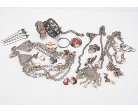 A collection of Middle Eastern white metal jewels, including bangles and cuffs, pendants and chains, hair pieces, enamel Siam