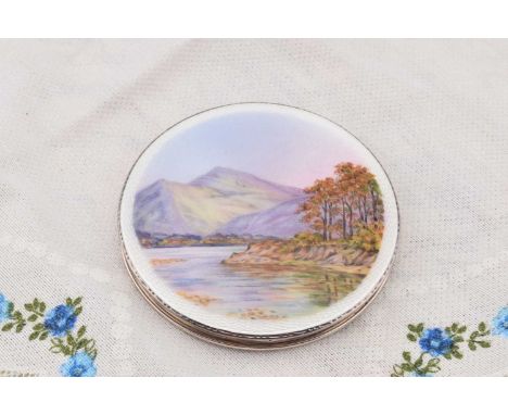 A circular silver, enamelled and painted compact depicting Derwent Water, A circular silver, enamelled and painted compact de