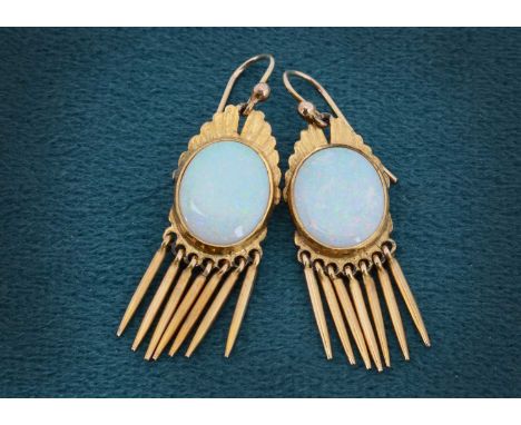 A pair of yellow metal and precious opal drop earrings,  the oval polished panels within a yellow metal surround, with tassel