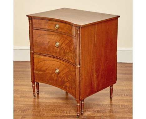The concave rectangular top above a drawer and cupboard over a pull-out commode with reeded flaring armrests and now with lat
