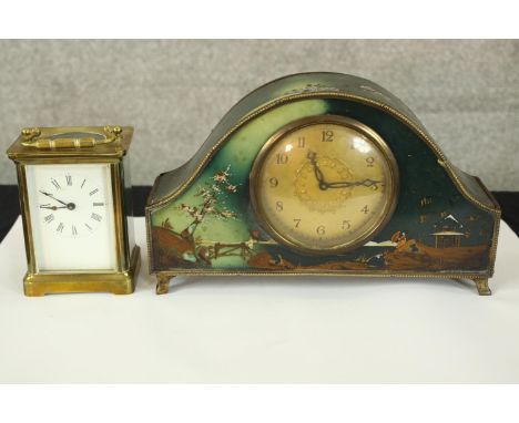 A mantel and carriage clock. The carriage clock with glass sides and exposed working. The mantle clock decorated with a hand 