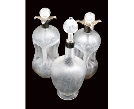 Two similar late Victorian ribbed glug glug decanters, of traditional shape with original spherical stoppers and silver colla