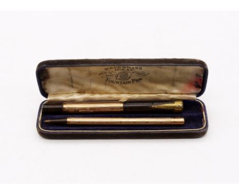 A Waterman's Ideal fountain pen and matching pencil set, both of stylish engine turned design with cartouches, one engraved J