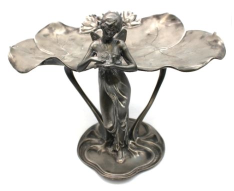 A WMF Art Nouveau silver plated comport, early 20th century, cast as a lily-pad with winged maiden standing stroking a dove, 