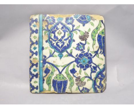 A C16th-C17th tile in Ottoman Iznik style manufactured in Damascus, Syria. Decorated with scrolling leaf pattern and floral s