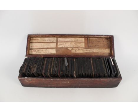 A box of glass lantern slides, black and white plus coloured including Victorian street scenes, ethnic studies, cricketer Jep