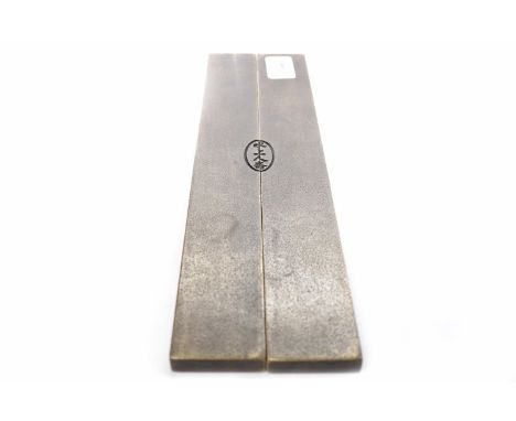 TWO MID 20TH CENTURY CHINESE CAST METAL SCROLL WEIGHTS each rectangular piece with a section of landscape in relief, mark to 