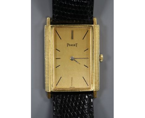 An 18ct gold Piaget rectangular dial manual wind wrist watch, on associated leather strap.