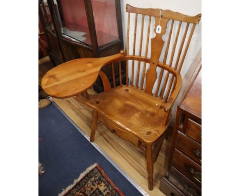 A reproduction yew and elm Windsor comb back armchair, with under seat drawer