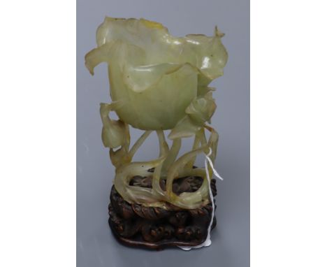 A Chinese bowenite jade 'lotus' vase, with carved wood stand