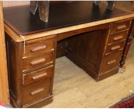 A 1920's oak pedestal desk W.135cm