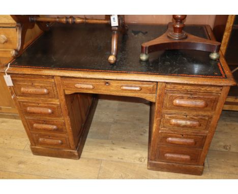 An early 20th century oak kneehole desk W.126cm