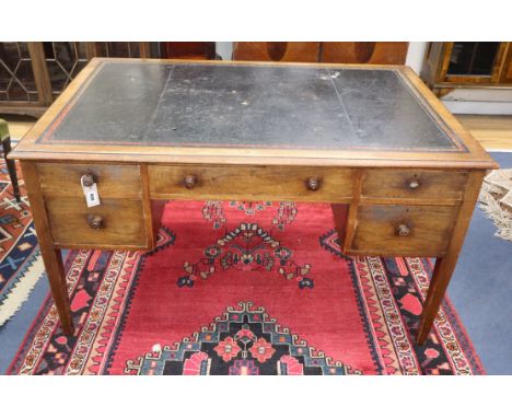 An early 20th century mahogany kneehole writing desk W.137cm