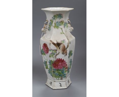 A Chinese famille rose hexagonal baluster vase, Guangxu period, painted with a bird amid pink flowers and foliage and a calli