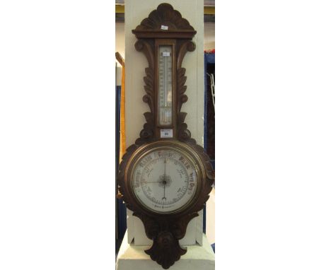 Early 20th Century carved oak aneroid wheel barometer.(B.P. 24% incl. VAT)