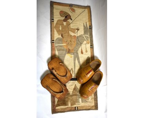 An Egyptian applique wall hanging depicting a male figure seated on a donkey, a pair of wooden clogs and a pair of vintage Ja